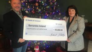 Michael Flatley presents Mary Gamble of Barnardos with cheque after auction