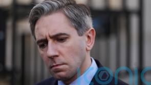 Woman in court charged with threatening Simon Harris