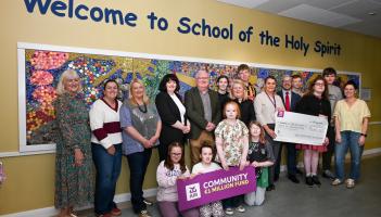 Jason Dempsey, AIB Kilkenny, AnnMarie Butler, principal of the School of the Holy Spirit, with staff  and pupils at the presentation of €26,000 from the AIB Community €1million  Fund