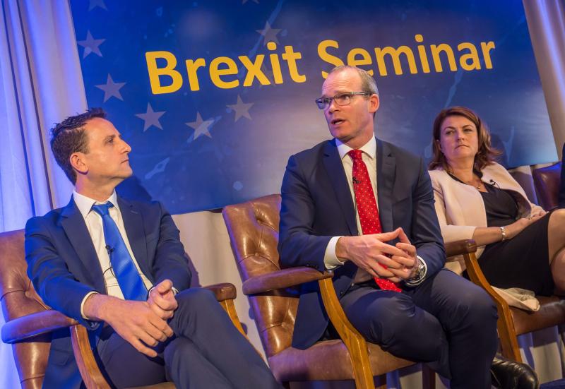 Tanaiste Simon Coveney (centre)m with Terry Clune on left and Ann-Marie McSorley on right.