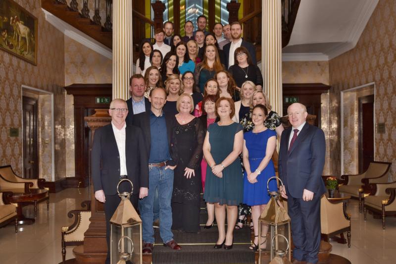 Tom O'Connor, pictured front left, with management and staff of O'Neill Foley, Kilkenny
