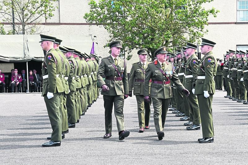Major General Kieran Brennan inspecting the guard of honour with his sons Kieran and Shane picture: Vicky Comerford