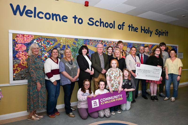 Jason Dempsey, AIB Kilkenny, AnnMarie Butler, principal of the School of the Holy Spirit, with staff  and pupils at the presentation of €26,000 from the AIB Community €1million  Fund