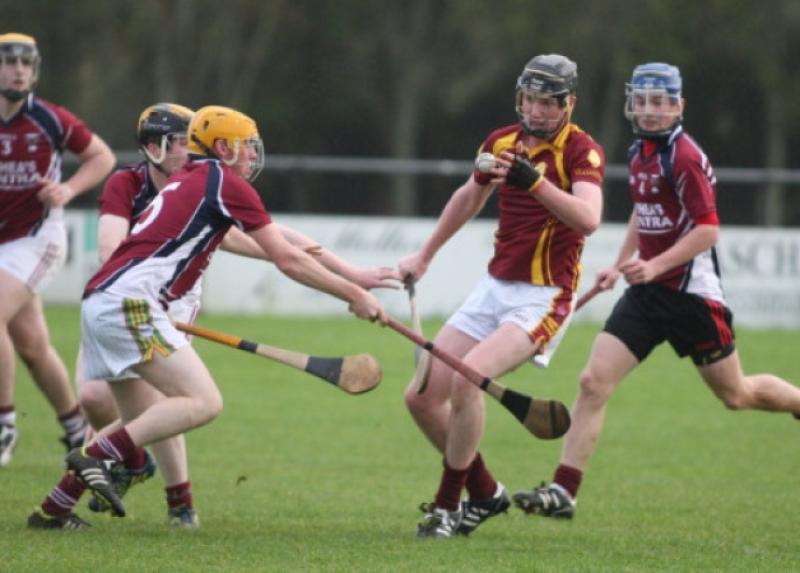 J.P. Treacy (Kilkenny CBS) handpasses the sliotar away as Seanie Whelan and Gary Lawlor (Borris) close in during the Leinster colleges hurling clash in Palmerstown. Photo: Eoin Hennessy