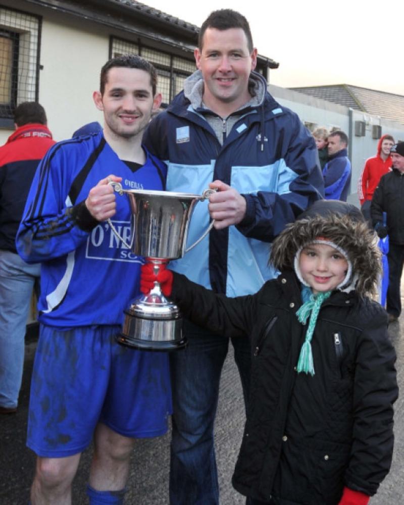 Davy Byrne and Emiilie Doyle, brother and niece of the late Ken and Michael Byrne, present the Division Two Byrne Memorial Cup to Freebooters B captain Shane Kelly. Photo: Michael Brophy