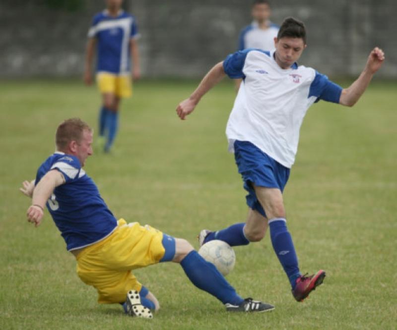 Aaron Molloy (Freebooters) is challenged by Jonathan Kennedy (Cashel Town) during the Moc Lawlor Memorial Tournament match on the Fair Green. (Photo: Eoin Hennessy)