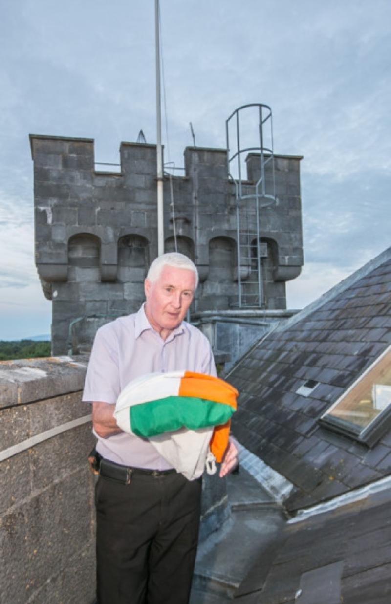Frank Kavanagh who retired from Kilkenny Castle on Tuesday, pictured as he takes down the Irish tricolour for the last time at work. Photo: Pat Moore.