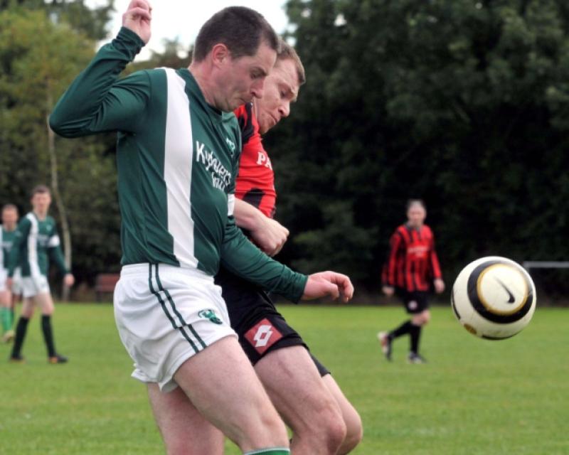 Eamon Hoyne (Tullaroan) tangles with Tadis Maliauka (Spa United). Photo: Michael Brophy