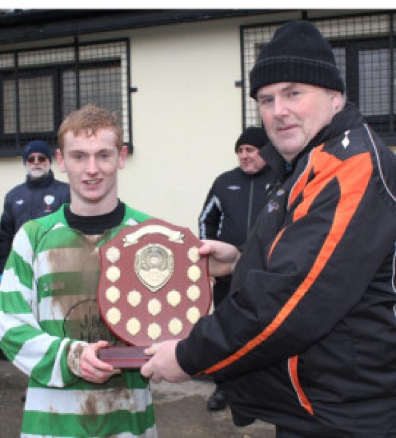 John Corrigan, chairman of the Kilkenny & District League, presents Evergreen's four-goal hero Cian Morton with the Henderson Youths' Shield. Photo: Eoin Hennessy