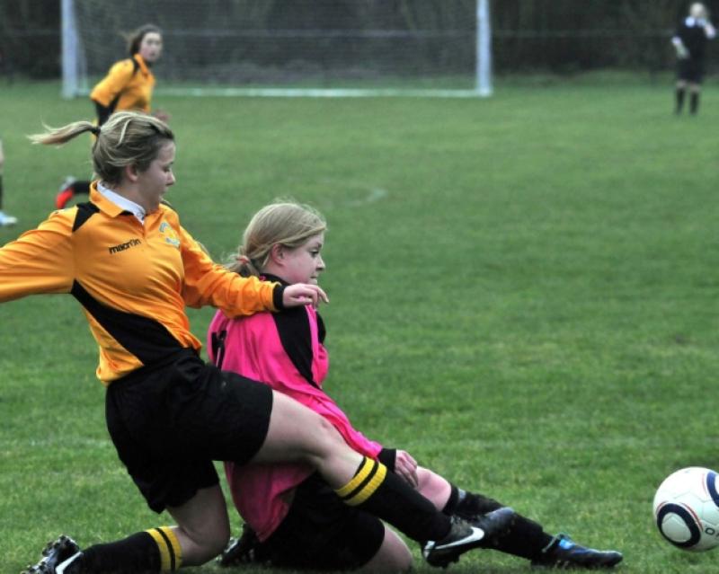 Laura Dooley (Kilkenny & District League) in a crunching challenge with Ali Lenehan (Combined Counties). Photo: Michael Brophy