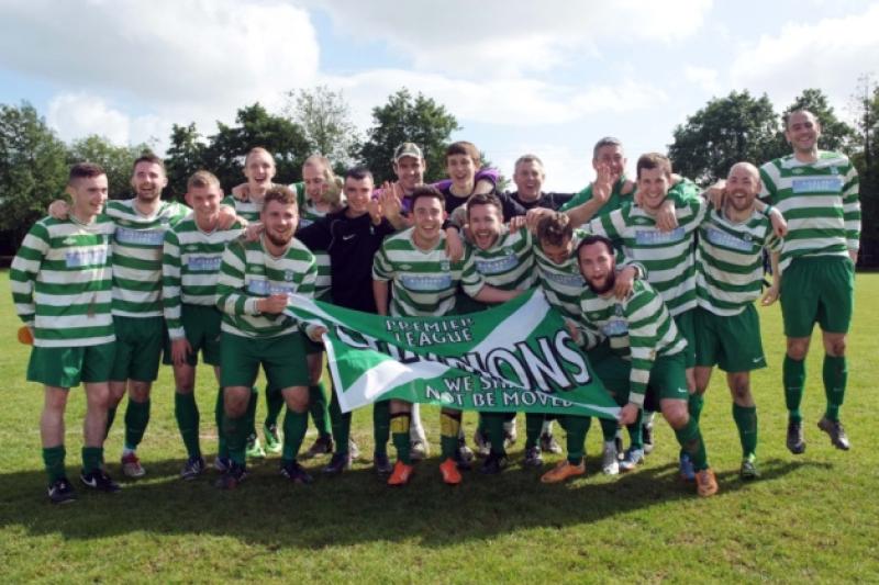 Fab five! The Evergreen A players, together with manager Eddie McEvoy and assistant John Treacy, celebrate winning their fifth Premier Division title in a row. Photo: Michael Brophy
