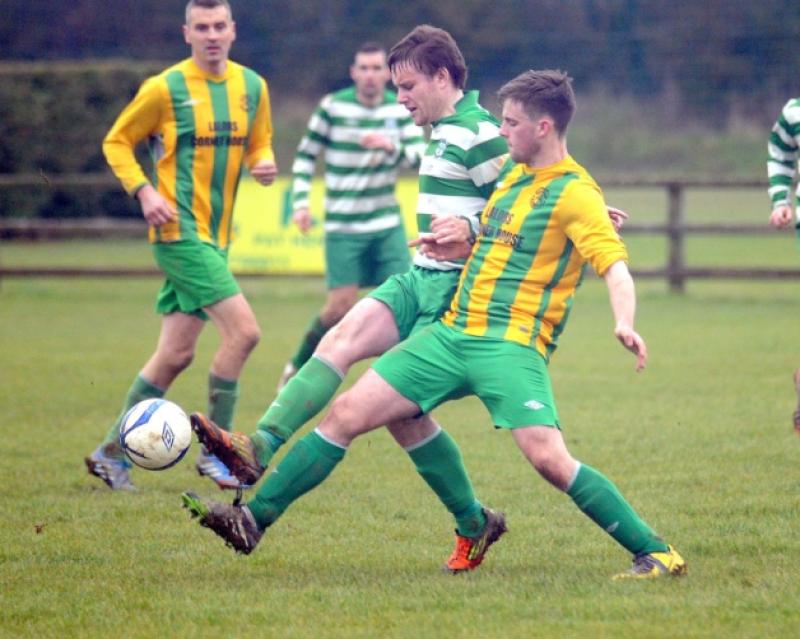 Tim Brennan (Evergreen B) moves in to challenge Killian Phelan (East End United A) during their Premier Division clash at the Kells Road. Photo: Michael Brophy