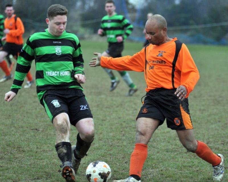 Eoin Connolly (Evergreen C) and Sonny Okonofor (St Mary's) challenge in action during the Division Two Cup clash on Sunday. Photo: Michael Brophy