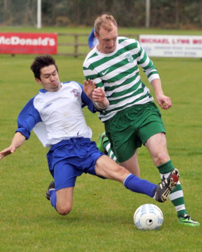 Jack Poyntz (Freebooters A) slides in to challenge Sean Barcoe (Evergreen A) during their Premier Division clash on the Kells Road. Photo: Michael Brophy