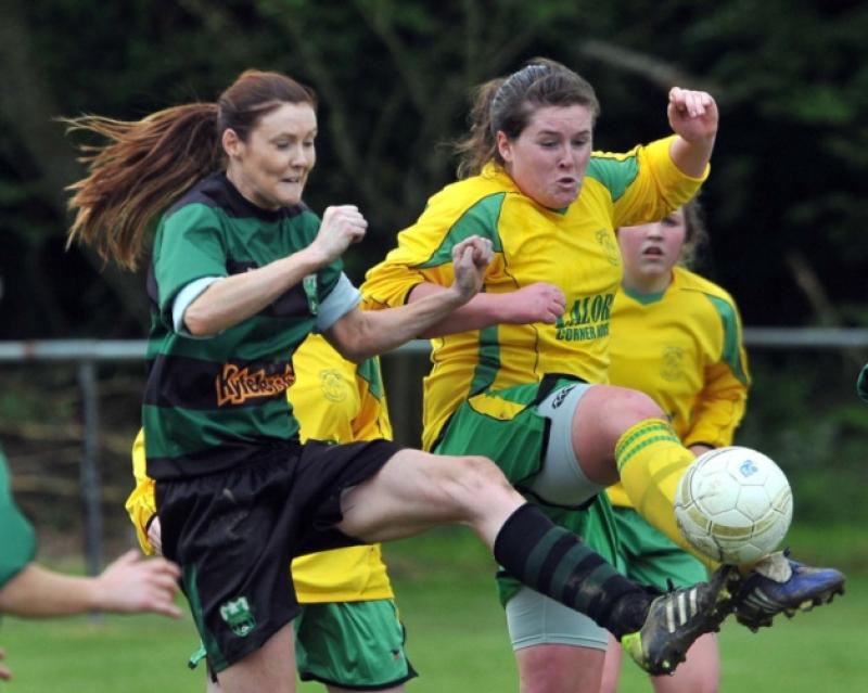 Niamh Bolger (East End United) makes the clearance as Breda O'Neill (Tullaroan) closes in during the Women's Division One play-off in Derdimus. Photo: Michael Brophy