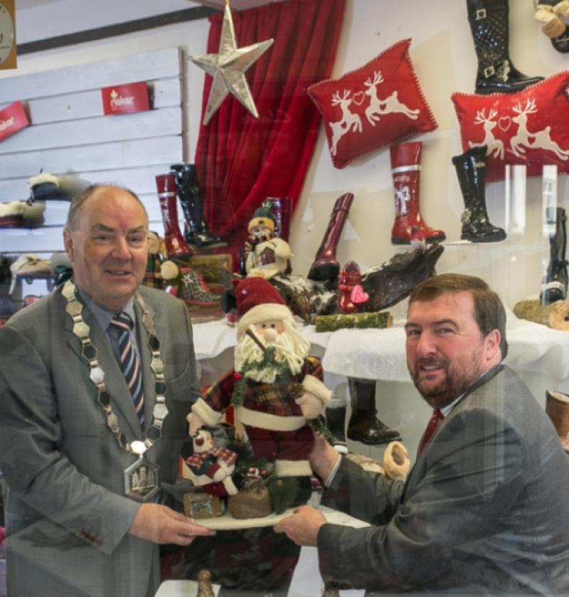 Business Community Get Behind A Very Kilkenny ChristmasThe local business community is getting behind Kilkennys inaugural Christmas festival  A Very Kilkenny Christmas  with a Winter Wonder Window competition to award the most festive window display in the run-up to Christmas. Kilkenny Chamber is sponsoring the initiative with Shop Local vouchers of �400 and �200 awarded to the respective business and stylist behind the winning window display. Pictured are Kilkenny Chamber President Donie Butler and Gary Graham, Chairman, A Very Kilkenny Christmas adding some festive d�cor to the window of Graham Shoes on Friary Street. Photo: Pat Moore.