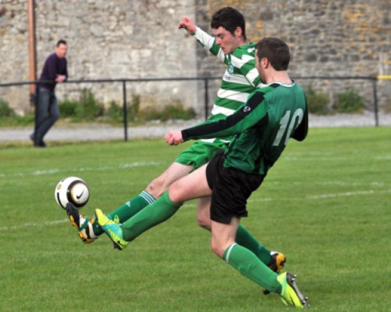 Ger Brennan (Tullaroan) and Gerry Walsh (Evergreen C) go toe-to-toe in the Division Two Ken and Michael Byrne Memorial Cup final at Derdimus on Saturday. Photo: Michael Brophy