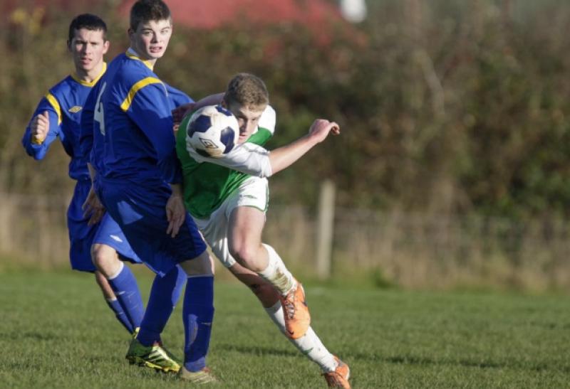 Cian Loy (Kilkenny & District League) bends his shot around the North Tipperary defence during Saturday's inter-league game in Drombane. Photo: Andy Jay