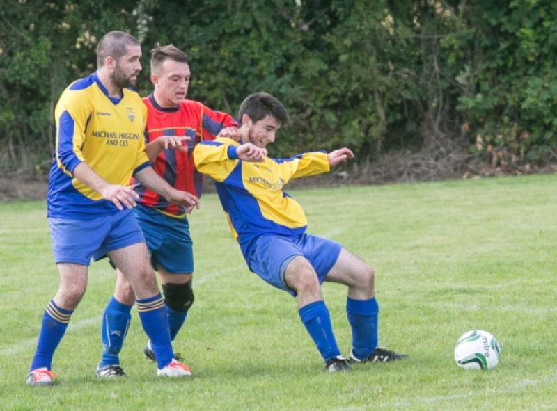 Kevin Davitt (Bridge United B) is held back by Paul Deniffe (Ormonde Villa) during the Division Two game in Goresbridge on Sunday. Photo: Pat Moore