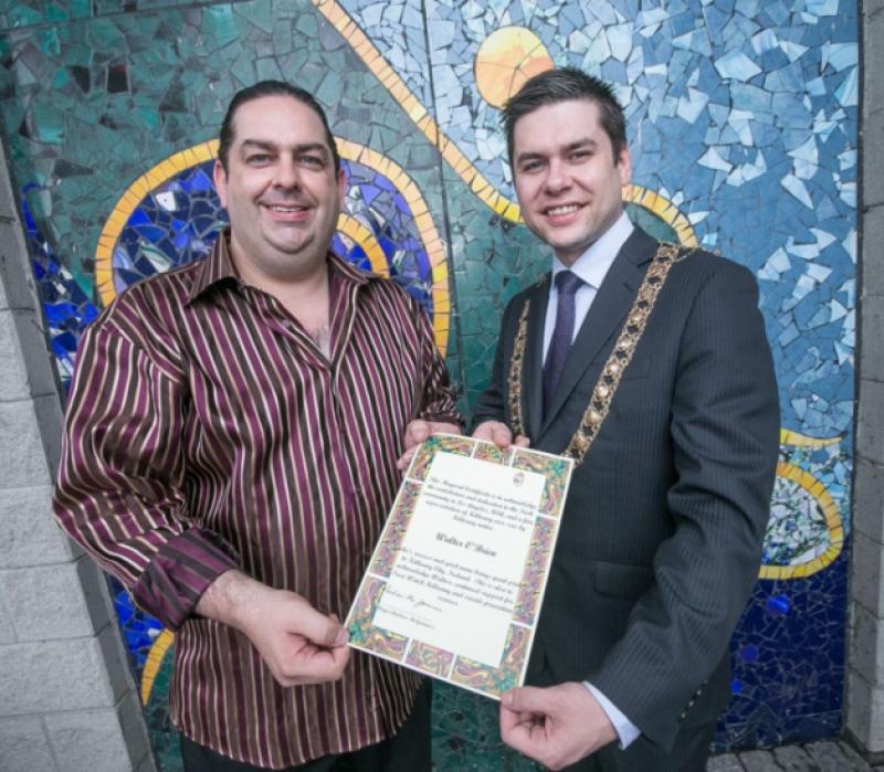 Mayor Andrew McGuinness presenting Walter O'Brien with a Mayor's Certificate in recognition of his contribution both at home and abroad to the good name of Kilkenny. Photo: Pat Moore.