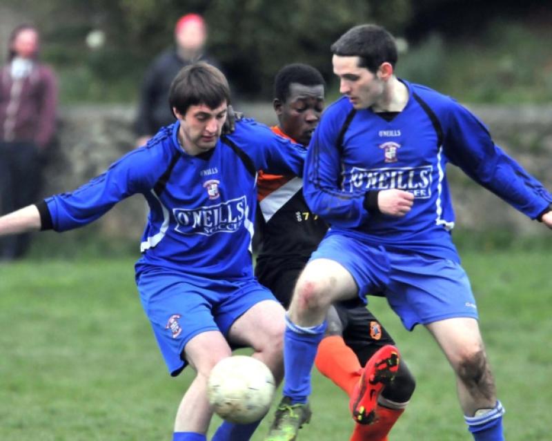 Shane Kelly and Richie Coyne (Freebooters B) team up to block out Gabriel Ajar (St Mary's). Photo: Michael Brophy