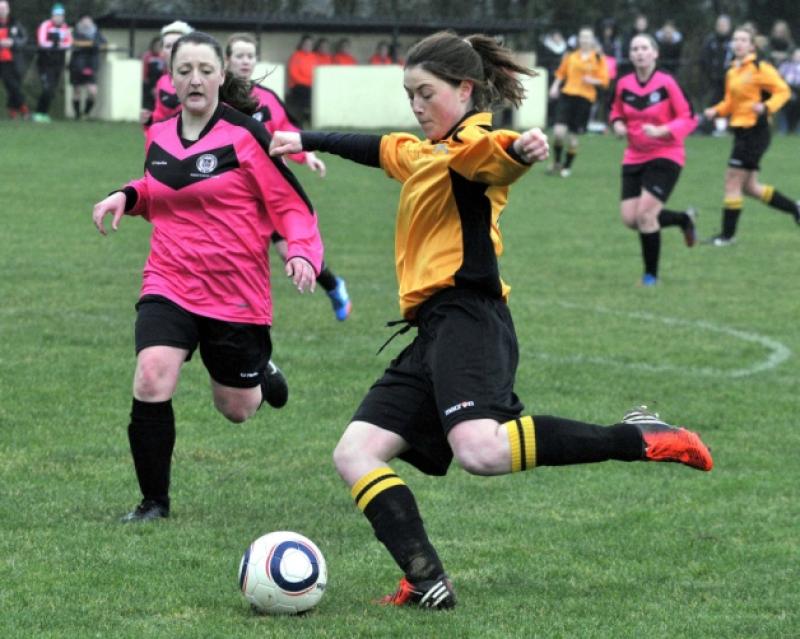 Jenny Brennan (Kilkenny & District League) takes a shot as Jackie Glennon (Combined Counties) closes in. Photo: Michael Brophy