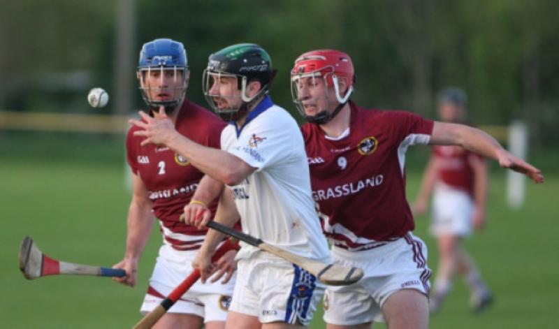 John Broderick (Fenian's) handpasses the sliotar away as Kieran Cuddihy and Cillian Buckley  (Dicksboro) closes in during the SHL encounter in Freshford. (Photo: Eoin Hennessy)