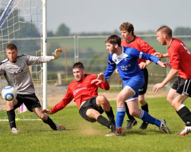 Barry Whelan (Thomastown United) finds room to shoot despite the crowded New Ross box during Sunday's Leinster Junior Cup clash in Thomastown. Photo: Michael Brophy