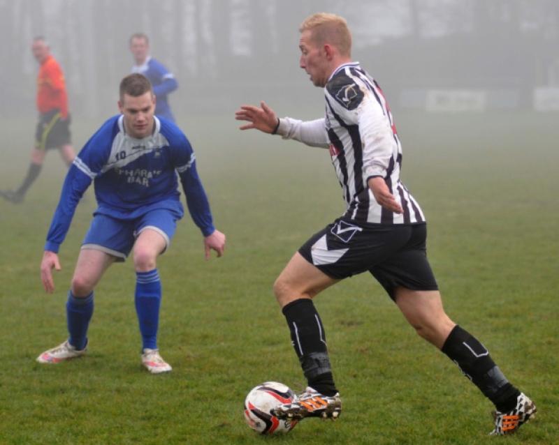 Michael Comerford (Newpark A) looks for space to get his cross in as Steven Connolly (Thomastown United A) closes him down. Photo: Michael Brophy