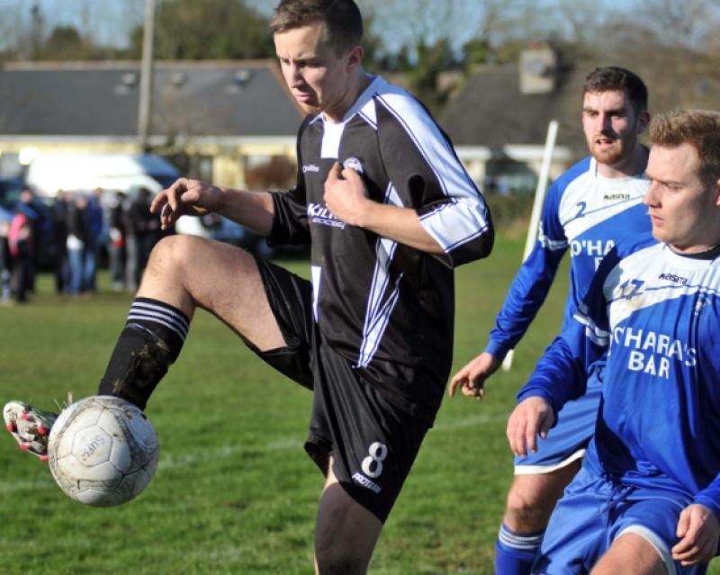 Conor Coffey (Stoneyford United) keeps control of the ball as Neil O'Mara and Andy Kavanagh (Thomastown United) look on. Photo: Michael Brophy