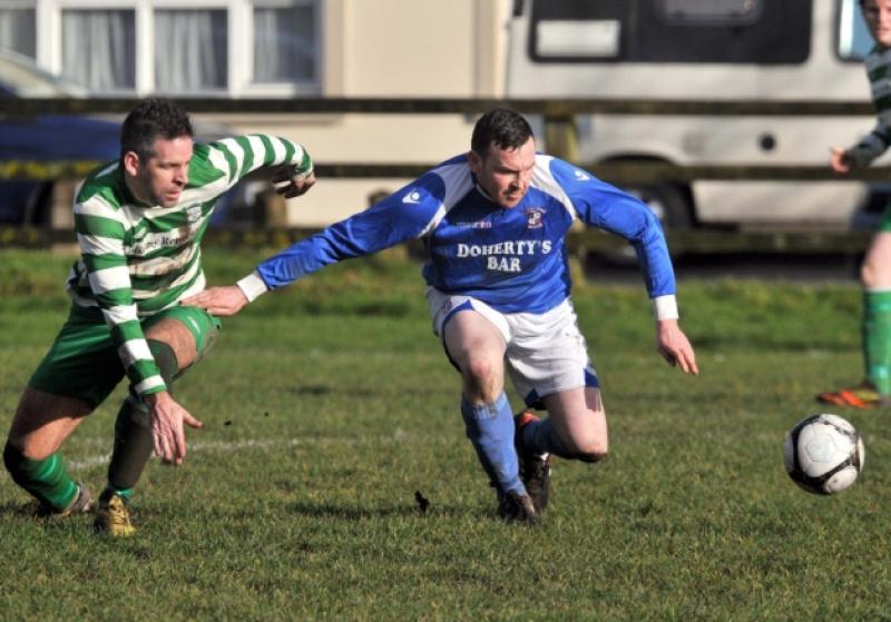 Ger Galvin (Evergreen B) and Damien Raggett (Freebooters A) keep their eyes on the ball during Sunday's Premier Division game at the Fair Green. Photo: Michael Brophy