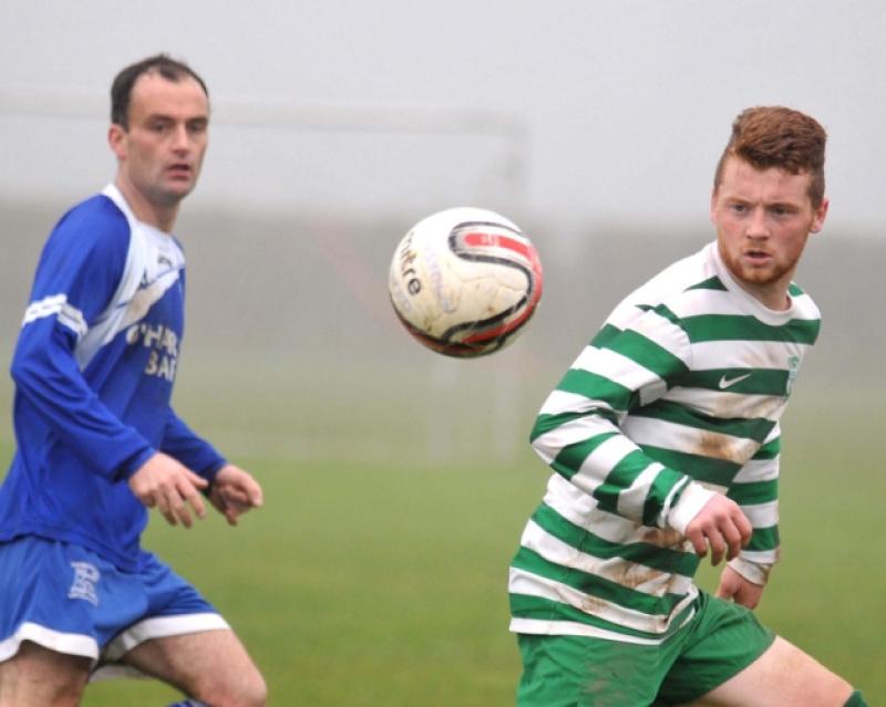 Paul Dempsey (Thomastown United A) and Conor English (Evergreen A) eye the ball. Photo: Michael Brophy