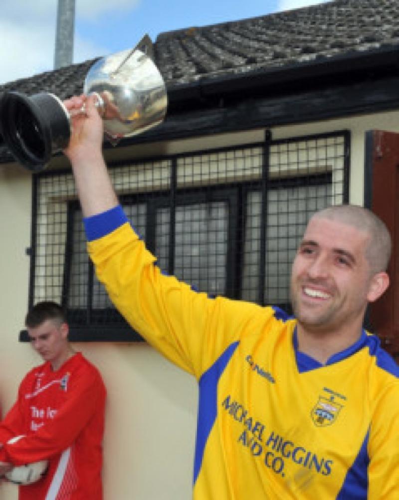 Bridge United B captain Shane Murphy raises the Division Three cup after his side's 4-2 win over St Ann's. Photo: Michael Brophy