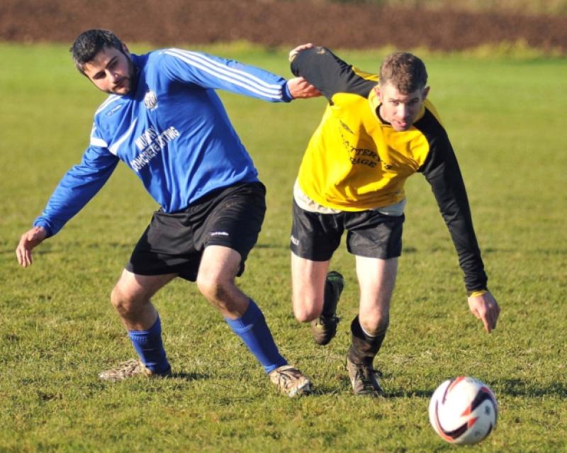 David Forristal (Fort Rangers) races to the ball ahead of James Moran (Stoneyford United). Photo: Michael Brophy