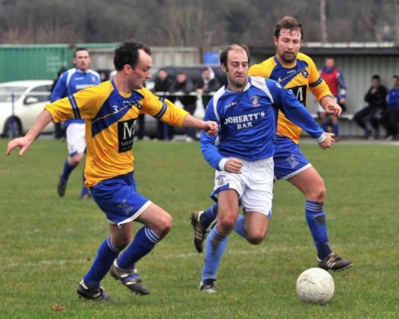 Race you to it - Paul Dempsey and Peter O'Hanrahan (Thomastown United A) compete with Geoffry Brennan (Freebooters A) for possession. Photo: Michael Brophy