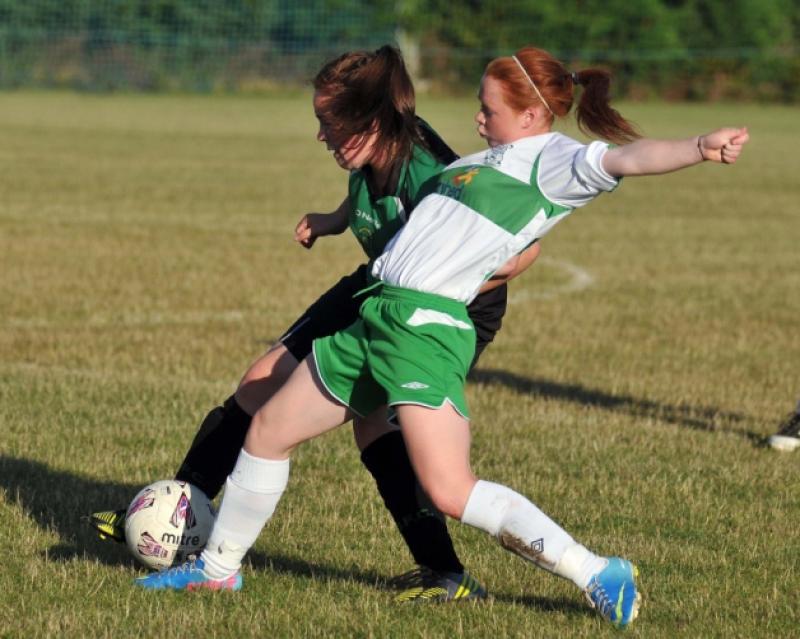 Jenny Clifford (Evergreen) reaches in to challenge Chloe Murphy (Peamount) for possession during the FAI Women's Under-16 Cup clash. Photo: Michael Brophy
