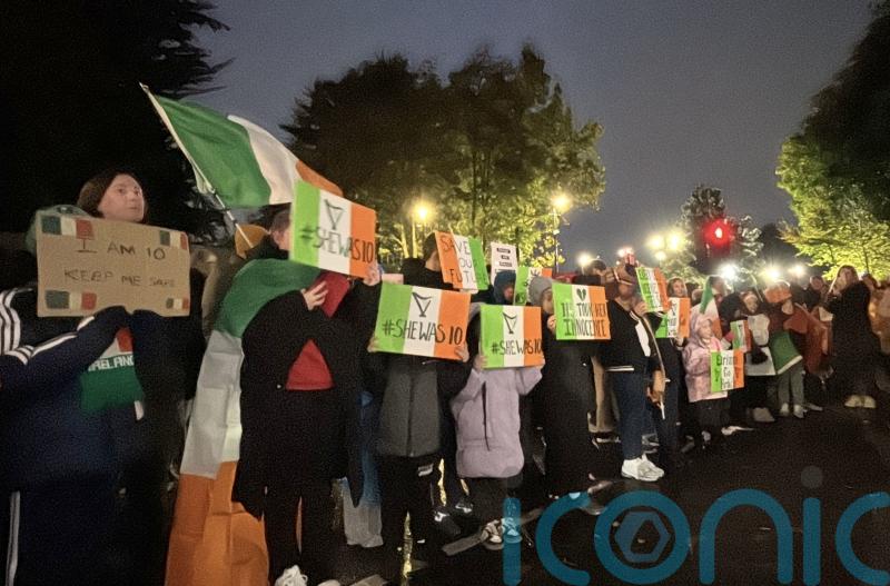 Protesters let off pink smoke during asylum demonstration at Citywest